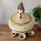Hand Made Chicken Shaped Egg Basket on a table with a green pot plant behind