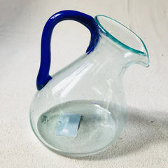 Blown glass slanted jug with blue handle